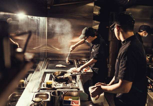 istock Key kitchen staff preparing meals for home delivery 1221881243