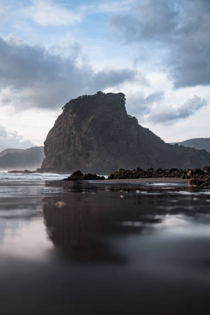 Low angle shot of New Zealand most popular black sand beach, Piha Beach. Located just outside Auckland in the north island.