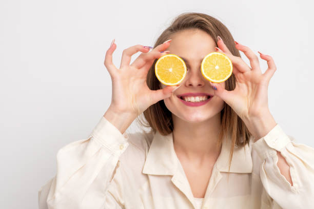 istock Woman covering eyes by halves oranges. 1221881459