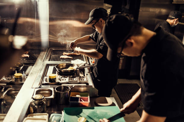 istock Key kitchen staff preparing meals for home delivery 1221881569