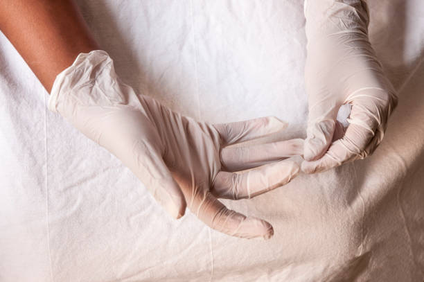istock covid-19 - Putting on gloves 1221881884