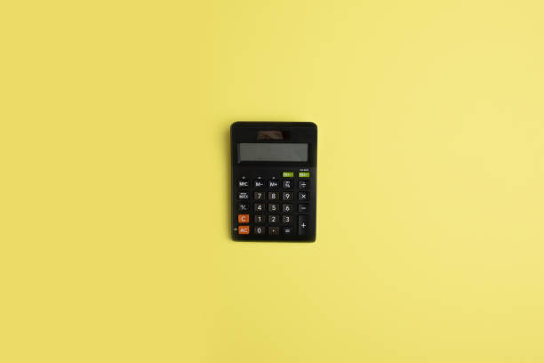 istock Black minimal calculator on solid yellow background for financial activity, accounting, tax calculation or saving and investment. 1221882715