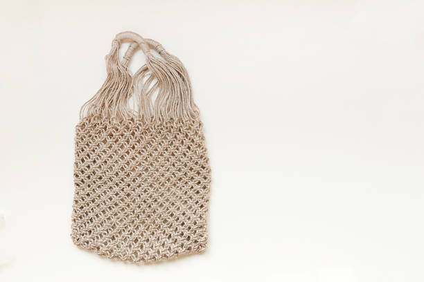 istock Reusable net bag or mesh shopper on beige background with copy space. Zero waste, plastic free concept. Eco friendly reusable mesh shopper. 1221883483