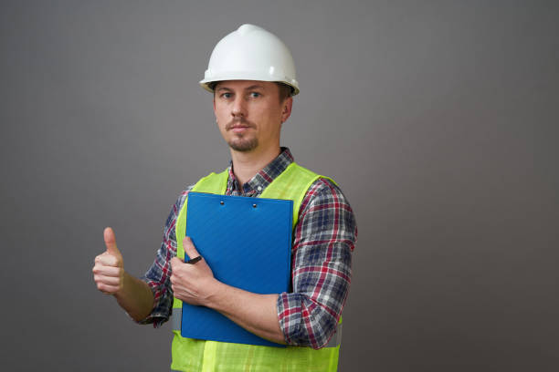 istock Worker man wearing protective hard hat and reflective vest. 1221884727