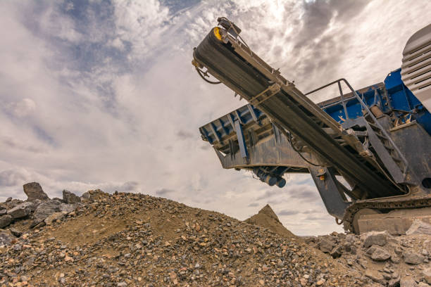 istock Heavy and mobile machinery in a quarry to transform stone into construction material 1221884900