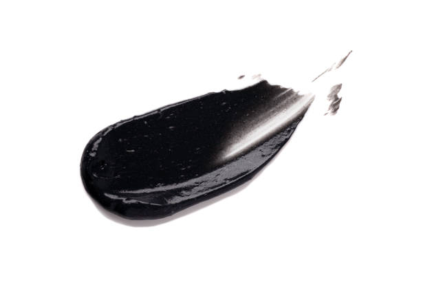 istock Black clay cream slide peel off mask sample foundation isolated on white background 1221886342