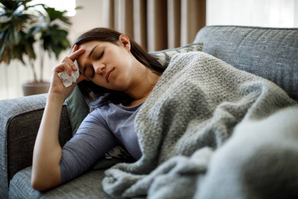 istock Sick woman lying in bed 1221887129