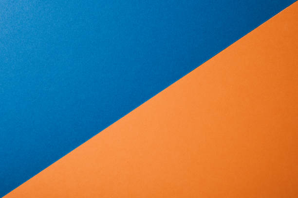 istock Blue and orange color paper background, texture, copy space, diagonal. 1221887130