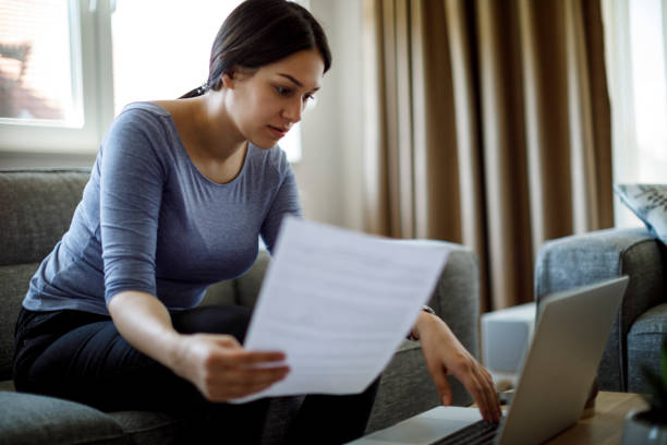 istock Serious young woman working from home 1221887371