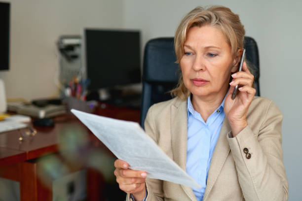 istock Senior businesswoman working with documents at office interior. 1221888788