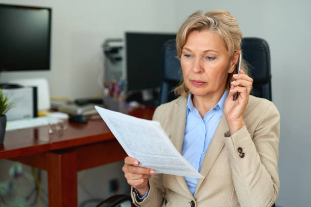 istock Senior businesswoman working with documents at office interior. 1221888797