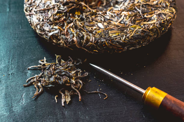 istock Pressed aged pu-erh tea cake and tea knife for tea ceremony. 1221889734