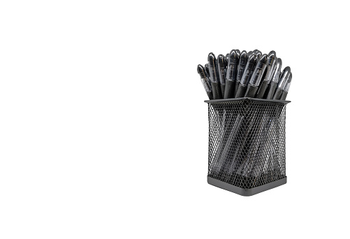 Black pens in holder basket isolated white background without shadow with copy space