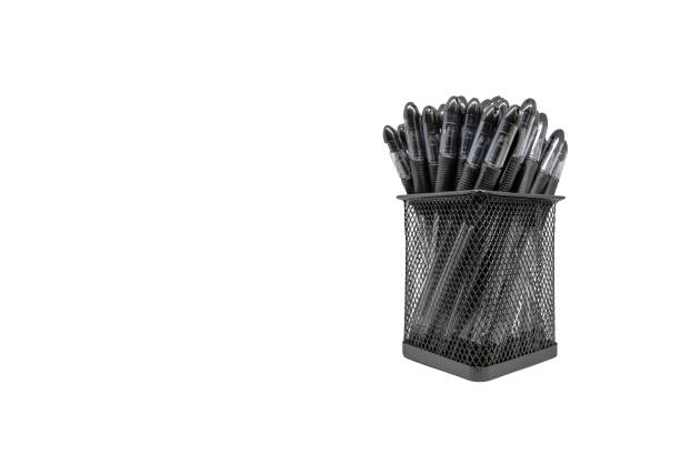 Pens in a black basket over a white background without shadow with copy space Black pens in holder basket isolated white background without shadow with copy space messy vs clean desk stock pictures, royalty-free photos & images