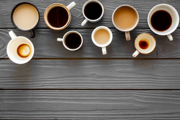 istock Many cups of coffee on wooden table top-down copy space 1221891218