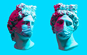 istock Creative concept of neon. Apollo statue In Medical Mask 1221891232