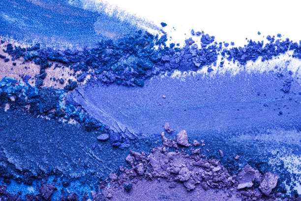 istock Crashed and smudged purple aquamarine blue eye shadow crumpled trampled on white isolated background 1221891646
