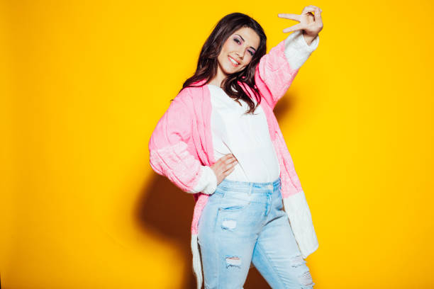 istock the girl in the pink jacket shows two fingers 1221892449