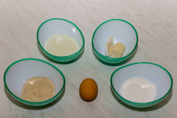 istock Baking background, ingredients for making sweet in bowls on light colored table 1221892496