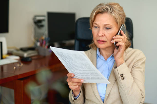 istock Senior businesswoman working with documents at office interior. 1221892501