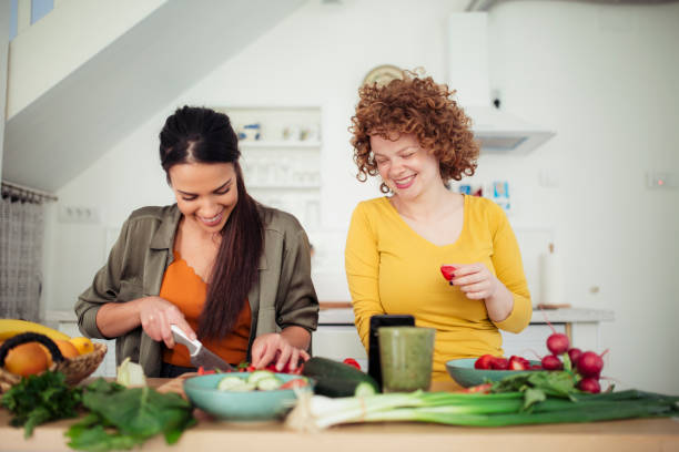 istock Two young women preparing food in the kitchen 1221894272