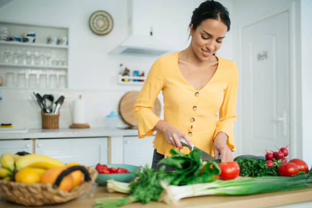 istock Attractive young woman preparing a meal 1221894347