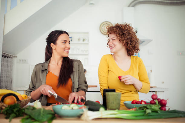 istock Two young women preparing food in the kitchen 1221894348