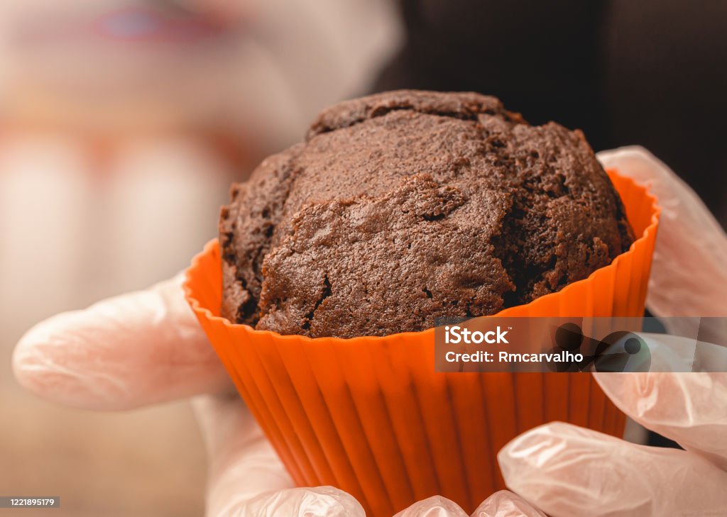 Chocolate cake in mini silicone cake pan . Woman holding a Chocolate cake in mini silicone cake pan. Baking Pan Stock Photo