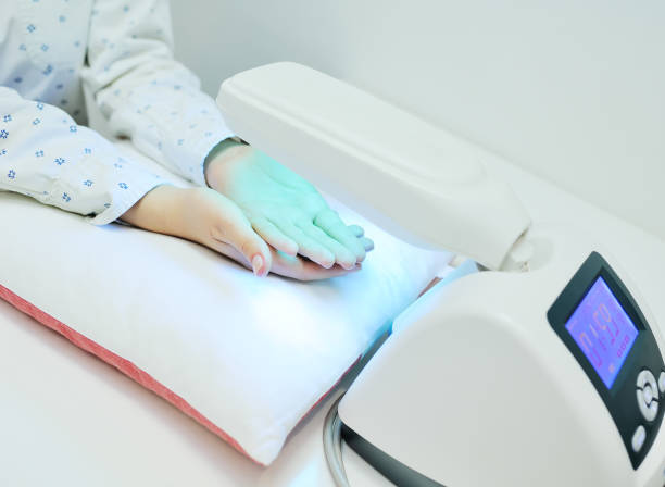 doctor spends psoriasis treatment using ultraviolet lamps and phototherapy stock photo