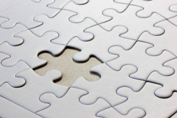 istock Close-up of a white puzzle with a missing piece 1221896556