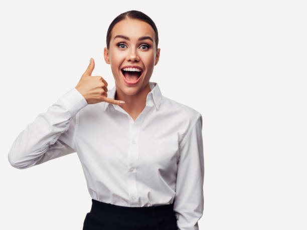 istock Business woman shows call me gesture 1221897168