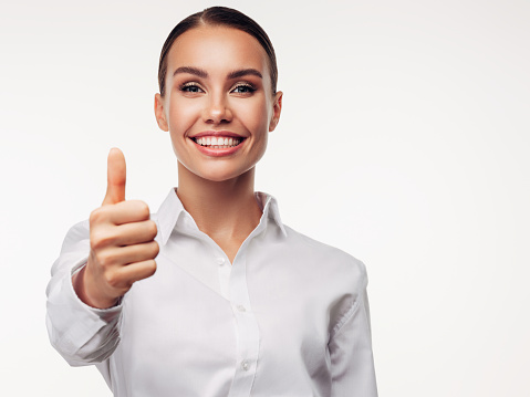 Excited businesswoman with thumbs up