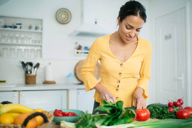 istock Attractive young woman preparing a meal 1221898766