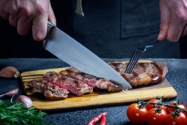 istock A chef cuts a freshly prepared steak into pieces. The meat is medium rare. Delicious restaurant meal 1221898794
