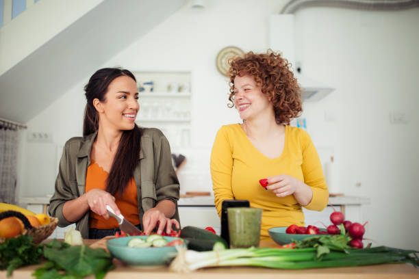istock Two young women preparing food in the kitchen 1221898821