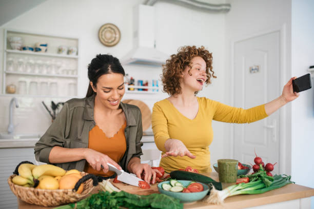 istock Two young women preparing food in the kitchen 1221898961