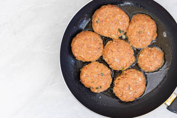 istock Frying meatballs in the frying pan with copy space 1221903551