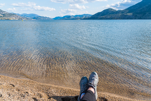 View of sandy beach, Skaha Lake and mountains in the Okanagan Valley in Penticton, BC, Canada