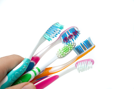 used toothbrushes on a white background