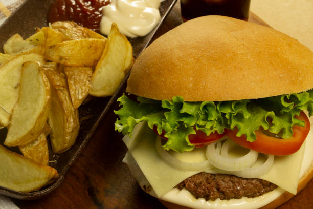 istock Homemade burger accompanied with rustic potatoes and soda 1221906420