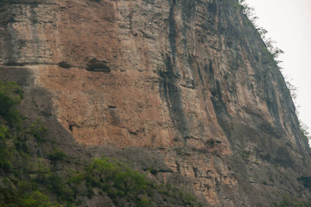 istock Caves on cliff at Dawu gorge on Daning River, Wuchan, China. 1221906645