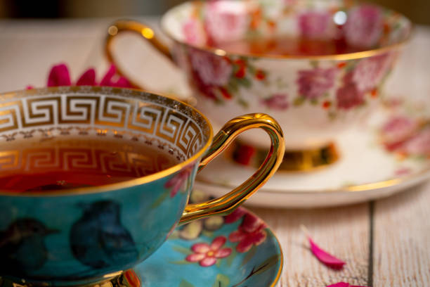 istock Pretty porcelain two teacups with black tea 1221908312