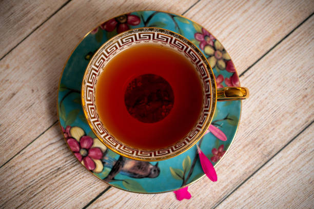 Black afternoon tea in a porcelain teacup on wooden table