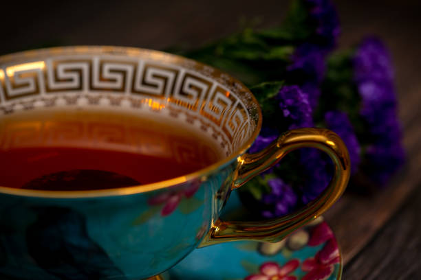 Black afternoon tea in a porcelain teacup on wooden table