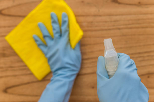 istock Disinfecting a table surface at home with rubbing alcohol for prevention of coronavirus covid-19 sars virus 1221909807