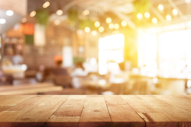istock Wood table top on blur restaurant interior background 1221913994