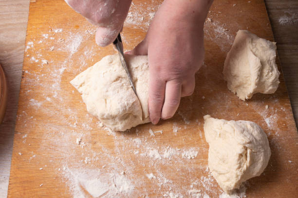istock Female hands mixing dough in the home kitchen. 1221914164