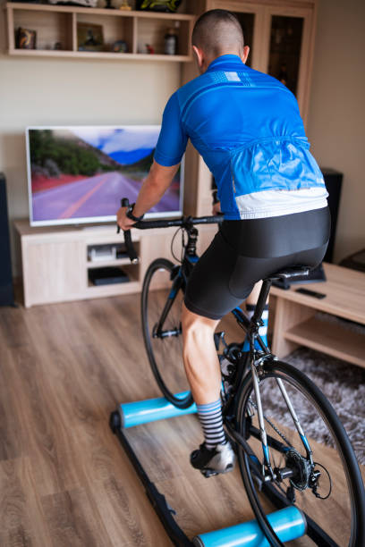 istock Sportsman Training At Home With Exercise Bike 1221914363