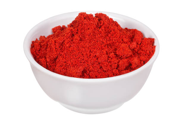 Paprika powder in the bowl Red pepper (paprika powder) sprinkled in a white bowl and isolated on a white background red pepper powder stock pictures, royalty-free photos & images