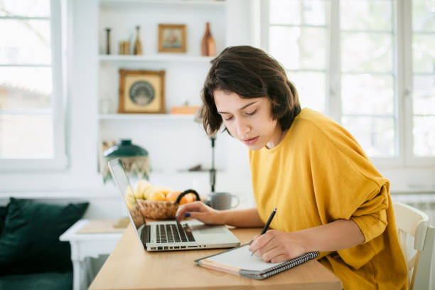 istock Side view of a young woman working from home 1221915401